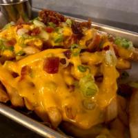 LOADED NACHO FRIES · Bacon, beer cheese sauce, green onions.