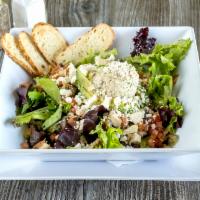 The Man Salad · House made tuna stuffed avocado, served on bed of spring mix greens, chicken, bacon, feta, t...