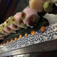 No Name Roll · Tuna, salmon and avocado inside yellowtail jalapeno on top with chef special sauce.
