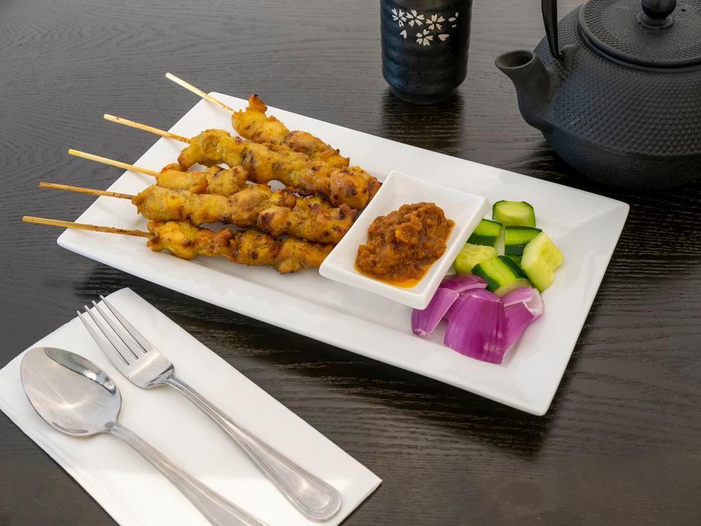 4. Satay · 5 sticks. Marinated beef or chicken on skewers, charcoal-grilled to perfection. Served with peanut sauce. Spicy.