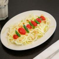 14. Thai Papaya Salad · Strings of pickled raw papaya and tomatoes topped with crushed peanut. Spicy.