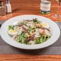 Taphouse Caesar Salad · Shaved Parmesan, homemade croutons, anchovies, hard boiled egg, and bacon served over romaine.
