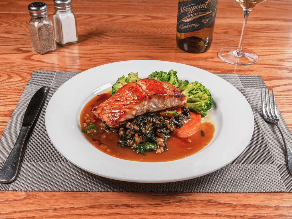 Grilled Salmon · Teriyaki glaze salmon over farro and a bed of spinach.