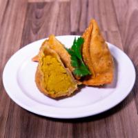 Vegetable Samosa · Spiced potatoes and peas in a pastry shell lightly fried. Vegetarian.