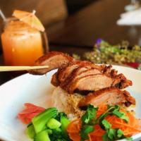 Roasted Duck over Rice · Crispy roasted duck over rice on the side with bok choy, ginger pickle and duck sauce.