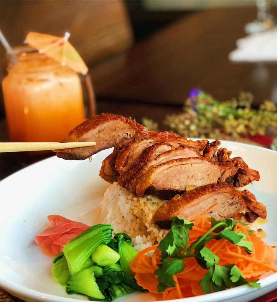 Roasted Duck over Rice · Crispy roasted duck over rice on the side with bok choy, ginger pickle and duck sauce.