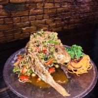 Laab Red Snapper · Fried crispy red snapper topped with Thai e-san aromatic herb, fresh mint, red onion, scalli...