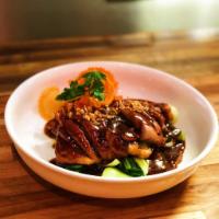 Duck Tamarind · Crispy roasted duck with tamarind sauce paired with steamed vegetables.