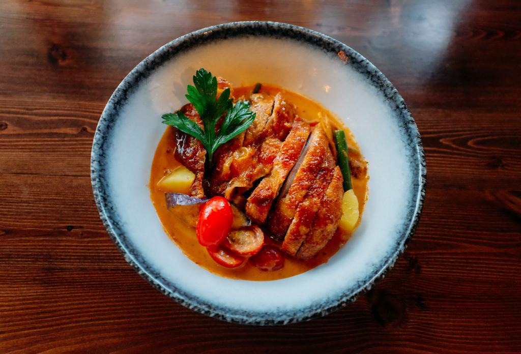 Duck Curry · Roasted duck, bamboo, bell pepper, green long hot chili, string beans, eggplants and basil served with choice of red or green curry sauce. Spicy.
