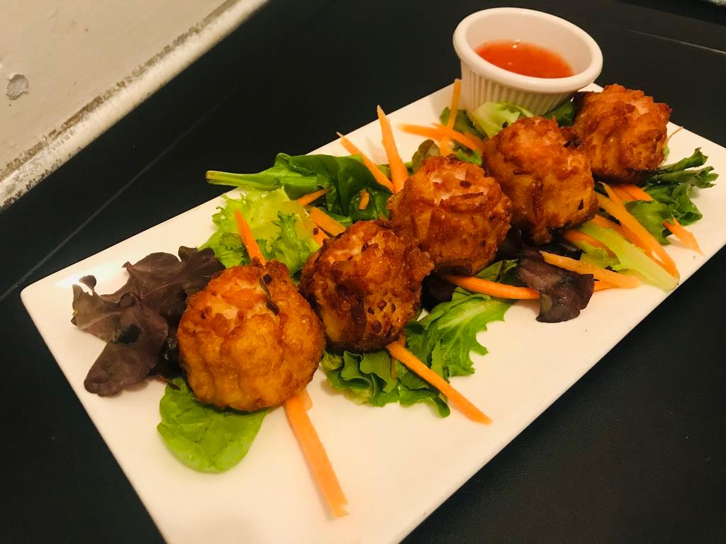 Fried Shrimp and Chicken Dumpling · Great homemade style appetizer with mix of ground chicken and shrimp wrapped in yellow wonton skin served with sweet chili sauce.
