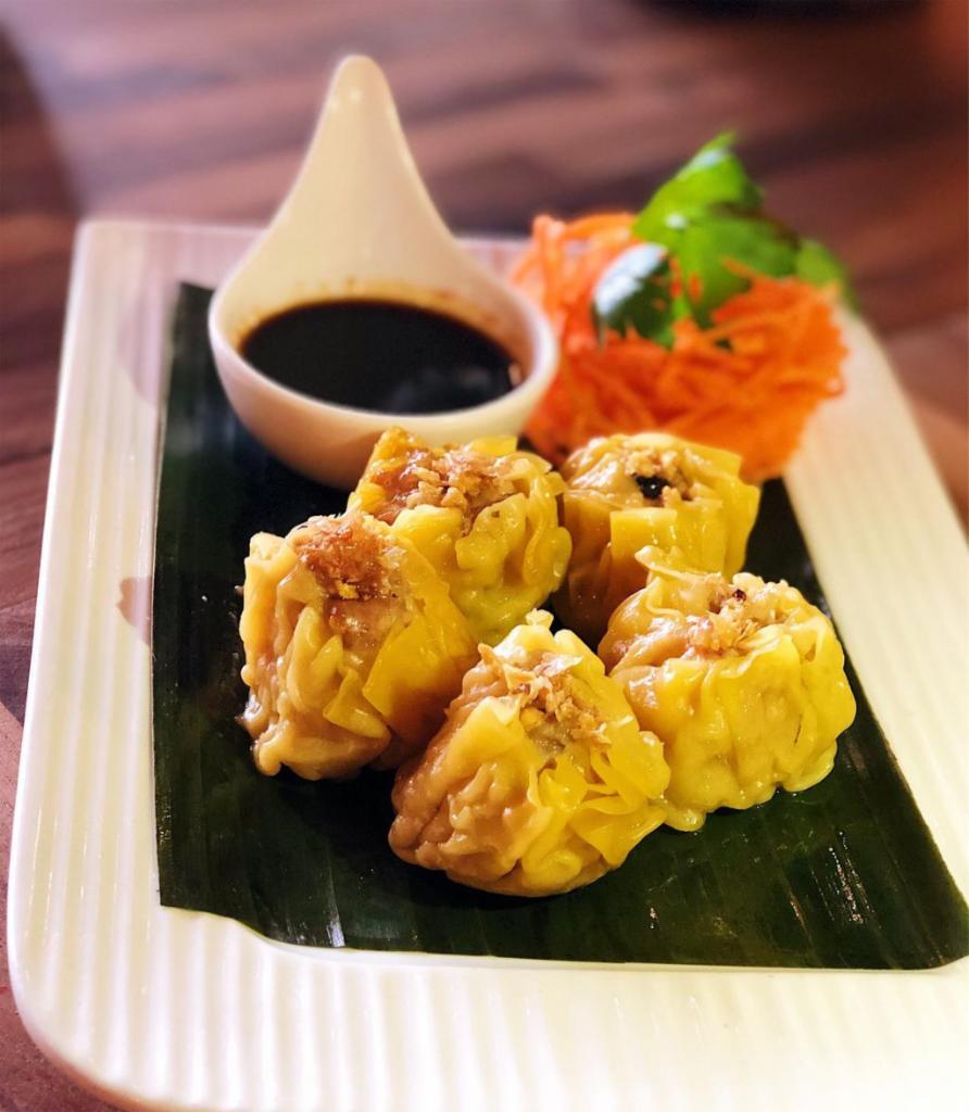 Steamed Shrimp and Chicken Dumpling · Great homemade style appetizer with mix of ground chicken and shrimp wrapped in yellow wonton skin served with sweet soy sauce.
