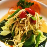 Papaya Salad (Som Tum) · Papaya salad. Thailand's signature zesty dish with stripped green papayas, cherry tomatoes, ...