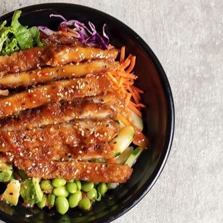 Panko Chicken Teriyaki Chili Peanut Bowl · Rice topped with sesame seeds, lettuce, edamame, cucumber, avocado, carrots, cabbage, beets, crispy panko chicken, sweet chili peanut sauce, teriyaki, sesame seeds, and pickled ginger.