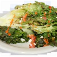 Grilled Romaine Salad · Grilled romaine served with tomatoes, fresh feta cheese and a dash of salt, drizzled with ou...