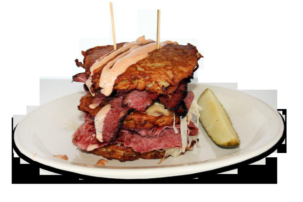NYBB Pile Up Sandwich · 3 of our famous potato pancakes piled high with corned beef, pastrami, kraut, Swiss, and a drizzle of Russian dressing.