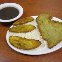 Cuban Bistec Empanizado · Breaded steak with rice, black beans and fried plantains. 