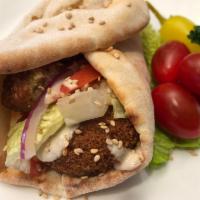 Five  Falafel Wraps. · On the Wrap: (5) Pieces of Falafel, Chopped Tomatoes,Chopped Lettuce, Chopped Red Onion, Hum...