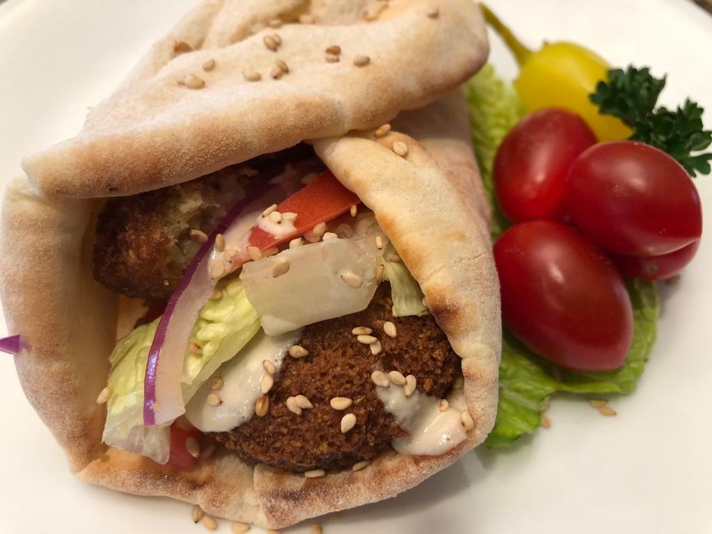 Five  Falafel Wraps. · On the Wrap: (5) Pieces of Falafel, Chopped Tomatoes,Chopped Lettuce, Chopped Red Onion, Hummus on Pita Bread Topped with Tahini Sauce.
