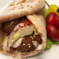 1. Falafel Wrap. · On the Wrap: (5)Pieces of Falafel, Chopped Tomatoes,Chopped Lettuce, Chopped Red Onion, Humm...