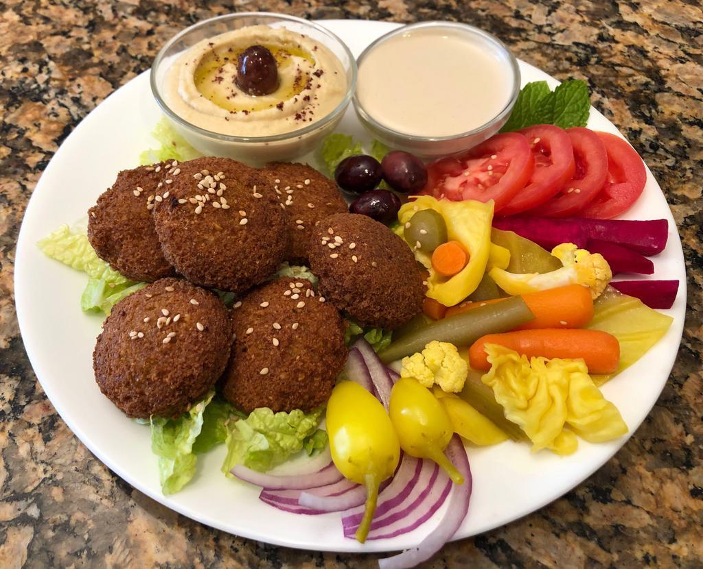 Falafel. · (8) Pieces of Falafel  served with Hummus, One (2) oz Container of Tahini and Hot Sauce,Lettuce,Turnip, Tomatoes,Turshi (Pickled Vegetables), Kalamata Olives,Red Onion, Hot Pepper and (2) Pita Bread.