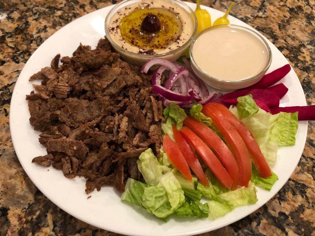 Shawarma. ·  Marinated Beef or Chicken served with Hummus, One (2) oz Container  of Tahini Sauce,Tzatziki Sauce Lettuce, Pickled Turnip, Tomatoes, Red onions and Pita Bread.