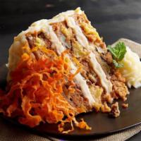 Carrot Cake · Three layers of subtly spiced carrot cake, generously covered with cream cheese frosting.