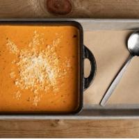 Creamy Tomato Basil Soup · served with parmesan cheese
