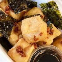 Fried Tofu · 8 pieces of fried tofu served with a light soy sauce and fried seaweed.