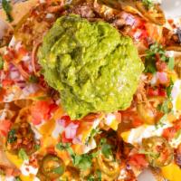 Loaded Nachos · Choice of Beer-braised pulled pork, Grilled Chicken, or Plant-based protein, nacho cheese, t...