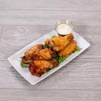 Wings · Flavorful chicken wings with a side of ranch dressing. Choice of: BBQ, Buffalo, and Parmesan...