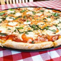 Margherita Artisan Pizza · Fresh sliced tomatoes, basil, mozzarella cheese, and olive oil over marinara sauce. Vegetari...
