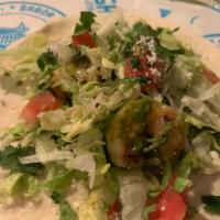 Chimi Shrimp Taco · Flour Tortilla, grilled shrimp, lettuce, tomato, cotija cheese, cilantro and chimichurri sauce