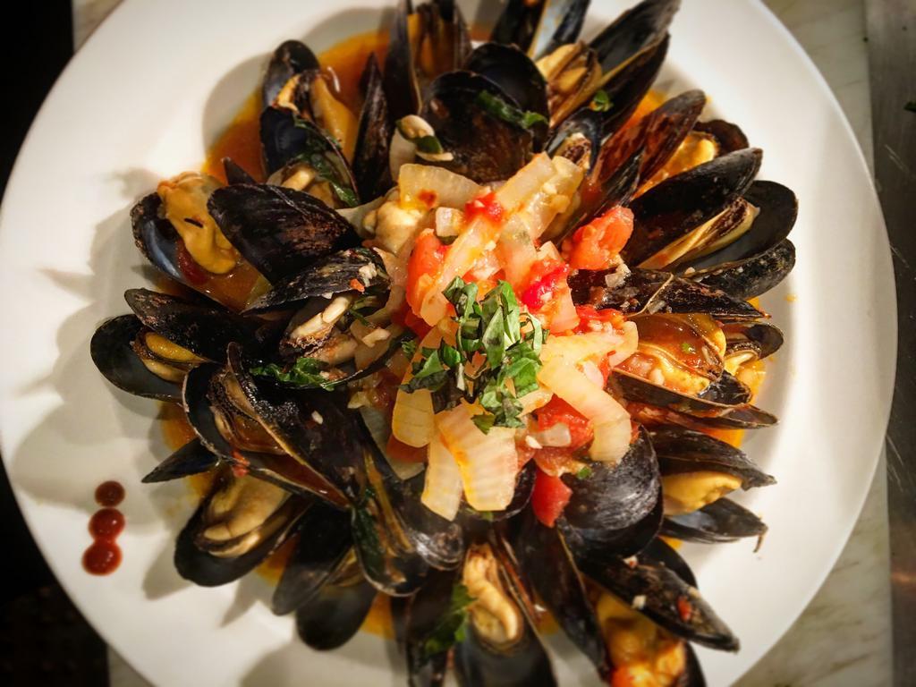 The Don · Sauteed P.E.I. mussels with onions, tomatoes, fresh basil, garlic, spicy marinara, crostini.