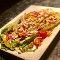 Grilled Romaine Salad · Charred hearts of romaine, bacon, red onions, tomato, Parmesan, crouton, anchovy aioli.