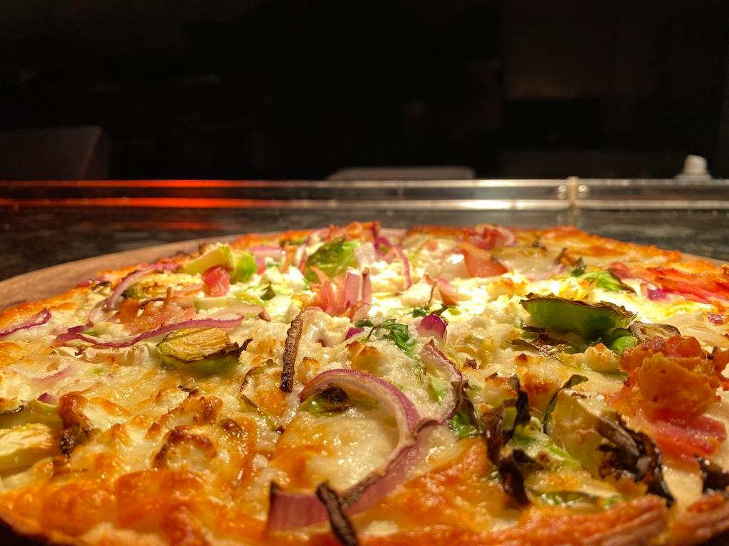 Brussels Sprouts Pizza · Creamy goat cheese spread, pancetta, red onion, shaved Brussels, light mozzarella.