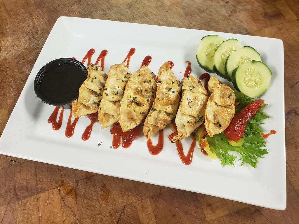 Pork and Kimchi Potsticker · Served with citrus wasabi dipping sauce.