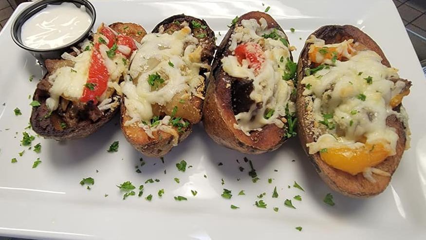 Philly Cheesesteak Potato Skins · Chopped ribeye, onions, roasted peppers, mozzarella, topped with sour cream.