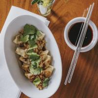 Gyoza Umami · Pork dumplings topped with fresh cilantro, French fried onions, and umami sauce.