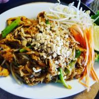 N1. Pad Thai · Small rice noodles in house pad Thai sauce with egg and green onions, garnished with bean sp...