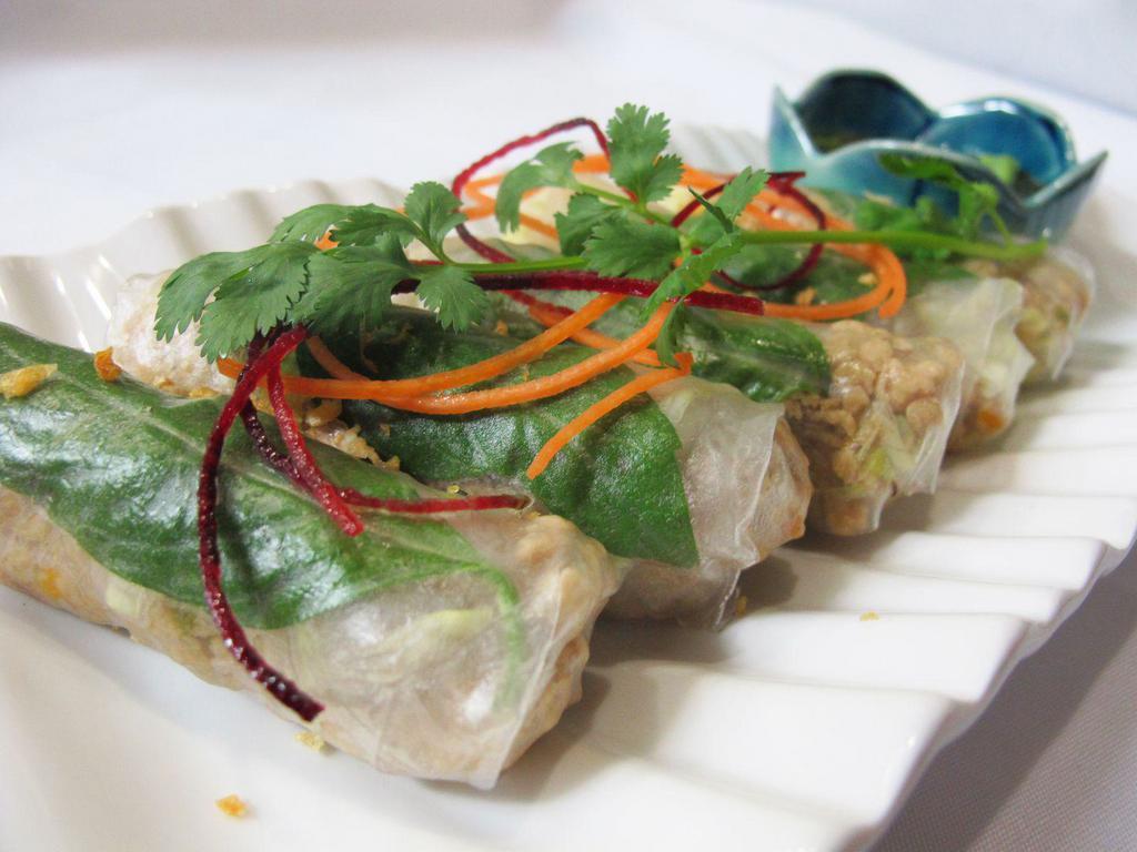 BASIL CHICKEN WRAPPED (5) · Minced chicken, basil leaves, carrots, onions & lettuce wrapped in steamed rice paper. (No alternations is possible)