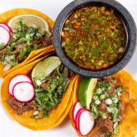 Birria Tacos with Consome · 3 Tacos topped with onions, cilantro, lime, and radishes, including a side of Consomé.