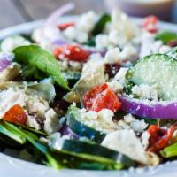 Mediterranean Spinach Salad · Served with a side of dressing.