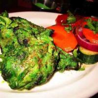 Hariyali Chicken Kabab · Chicken marinated with fresh green herbs served with grilled onion and salad.