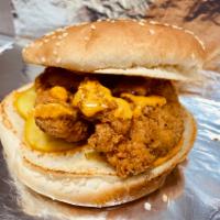 Spicy Chicken Sandwich · Crispy breaded chicken on top of a lightly toasted brioche bun with Blazin Cajun sauce and p...