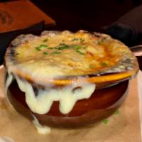 Classic French Onion Soup · Slow-simmered onion broth, housemade crouton topped with Swiss cheese. 