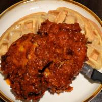 Nashville Hot Chicken & Waffles  · Buttermilk battered chicken thighs,
Belgian waffle, Nashville hot sauce,
brown sugar butter