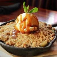 Apple Crisp · Warm apple crisp served with vanilla ice cream and topped with caramel.