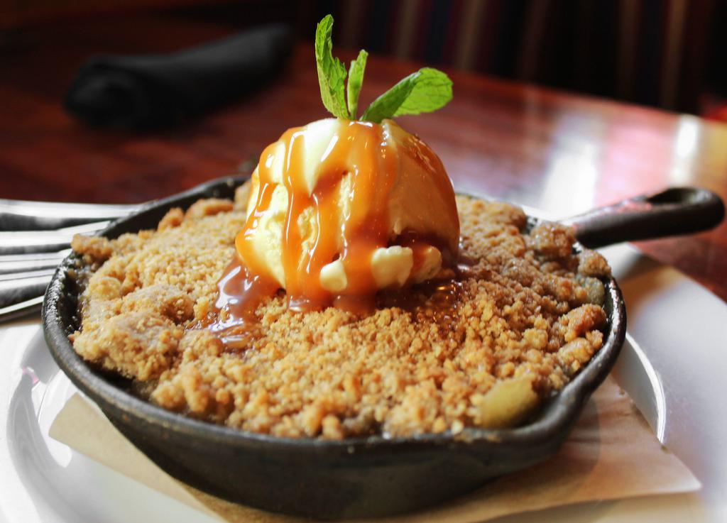 Apple Crisp · Warm apple crisp served with vanilla ice cream and topped with caramel.