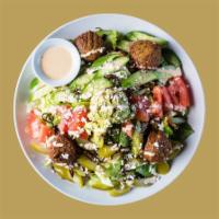 Falafel Cobb Salad · Romaine and iceberg lettuce, topped with tomatoes, cucumbers, pickles, caramelized onions, a...