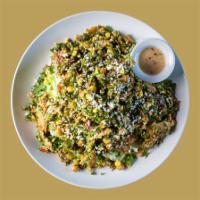 Shawarma Tabouli Salad · Romaine and iceberg, topped with tabouli, corn, black beans, roasted pepper, raisins, topped...